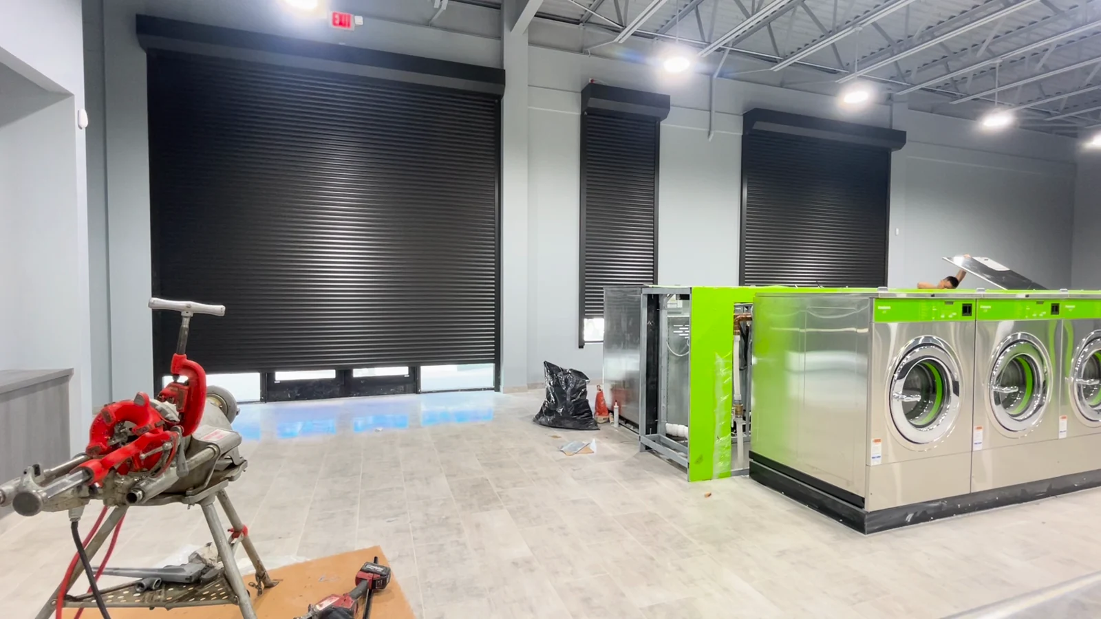 Black Rolluu security shutters inside a commercial space