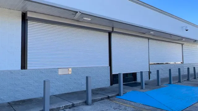 A clean white storefront. Rolling shutter installation