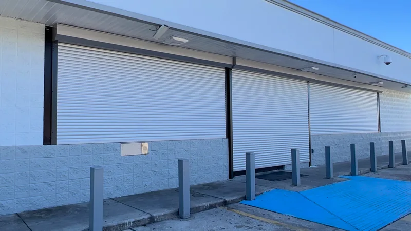 Rolluu shutter installation along a wide storefront